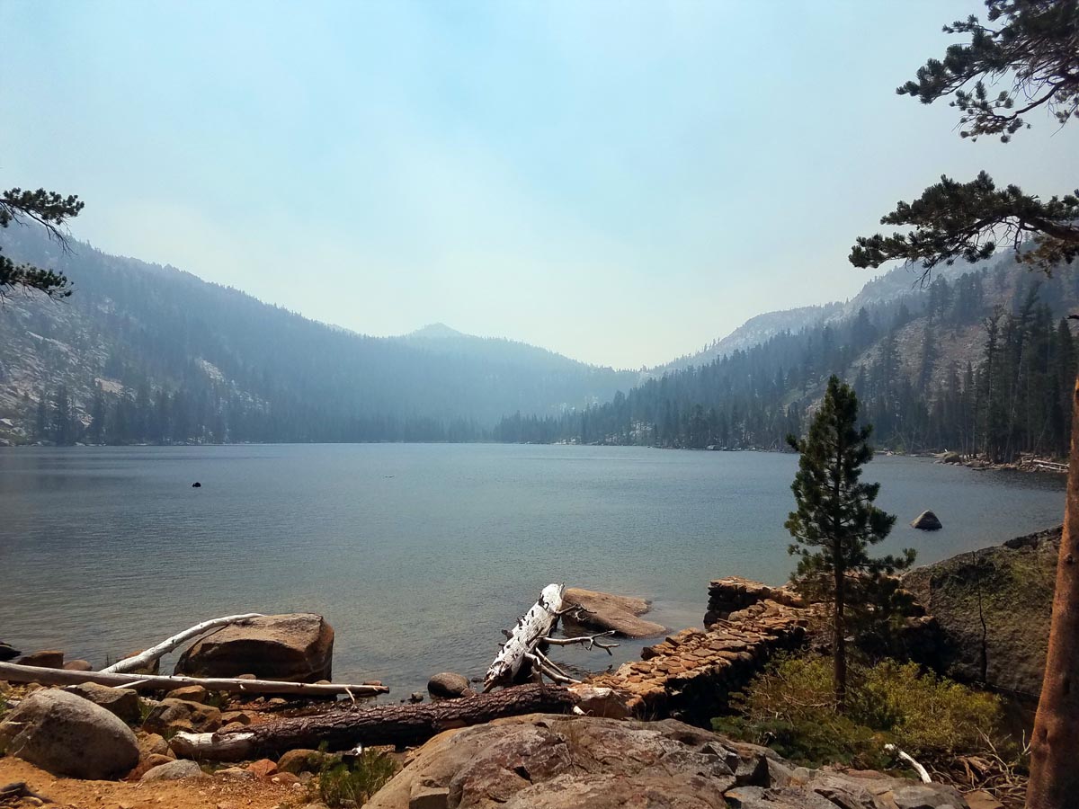 a lake surrounded by trees and rocks
