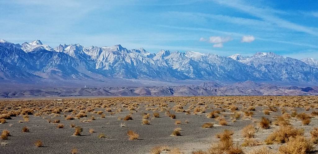 a desert with mountains in the background