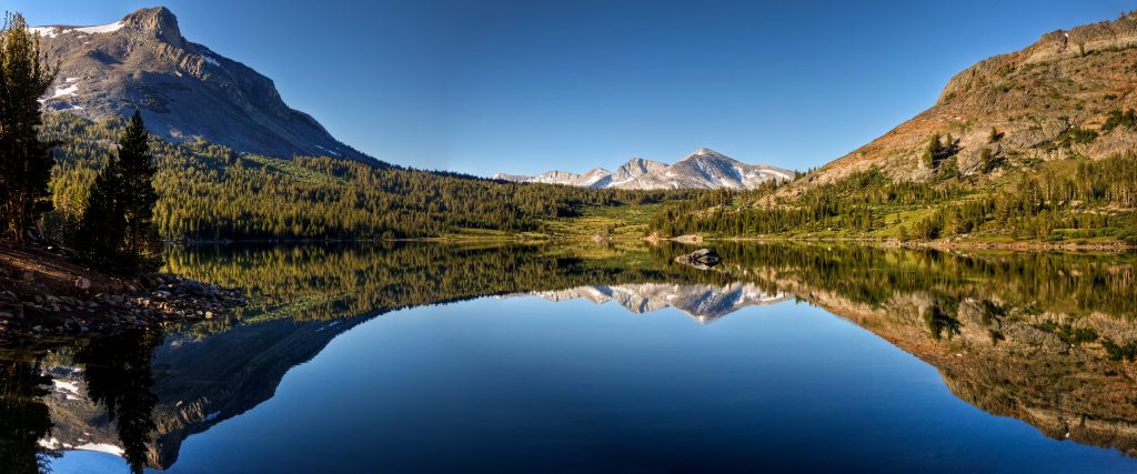 a mountain range is reflected in a lake