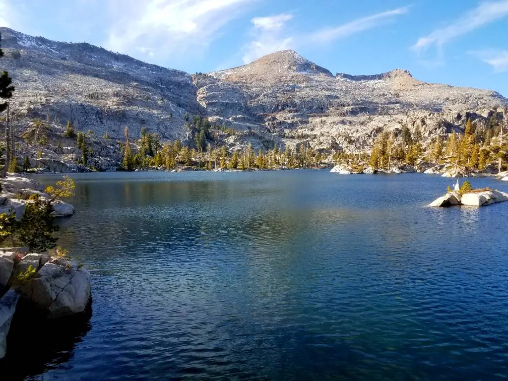 a lake surrounded by mountains and trees
