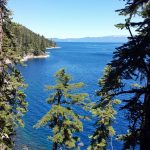 a view of the lake from the top of a hill