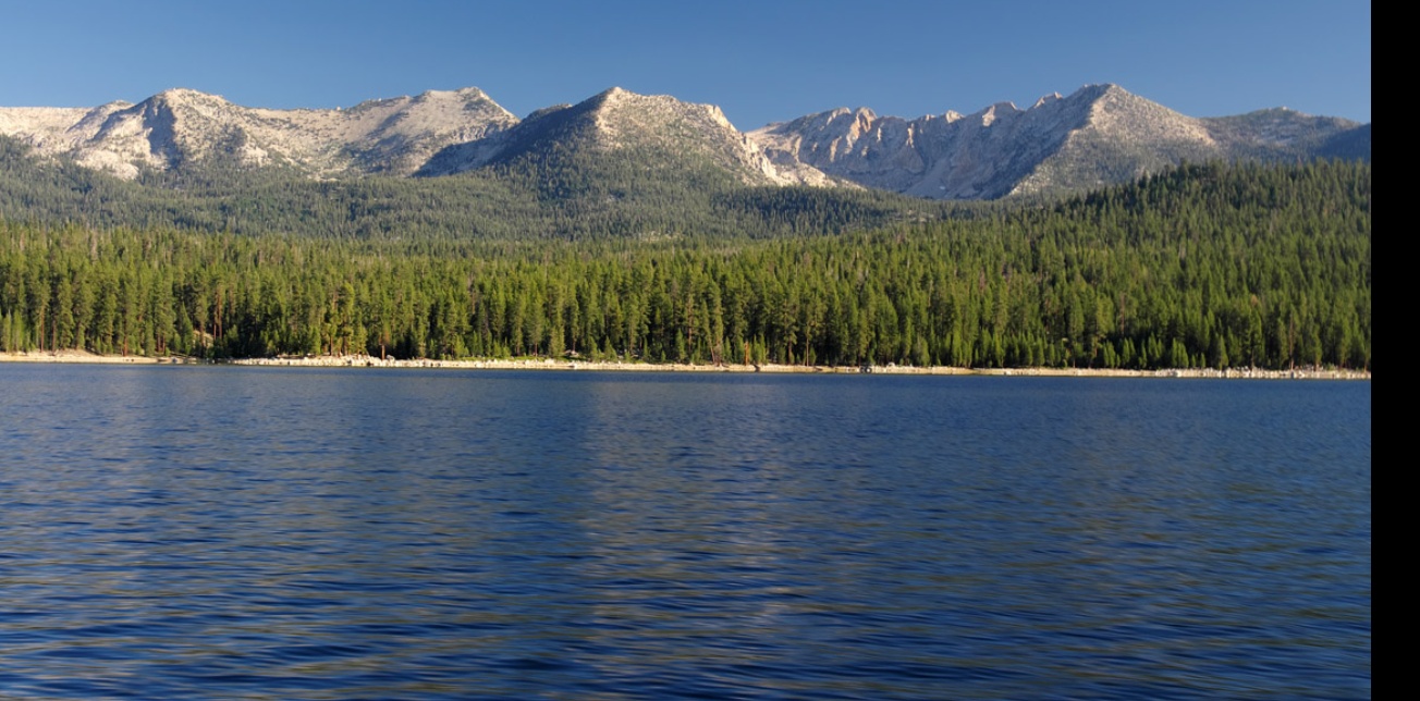 a body of water with mountains in the background