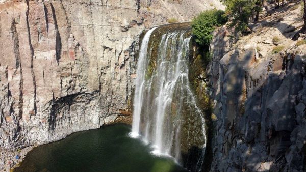 a waterfall is shown in the middle of a canyon