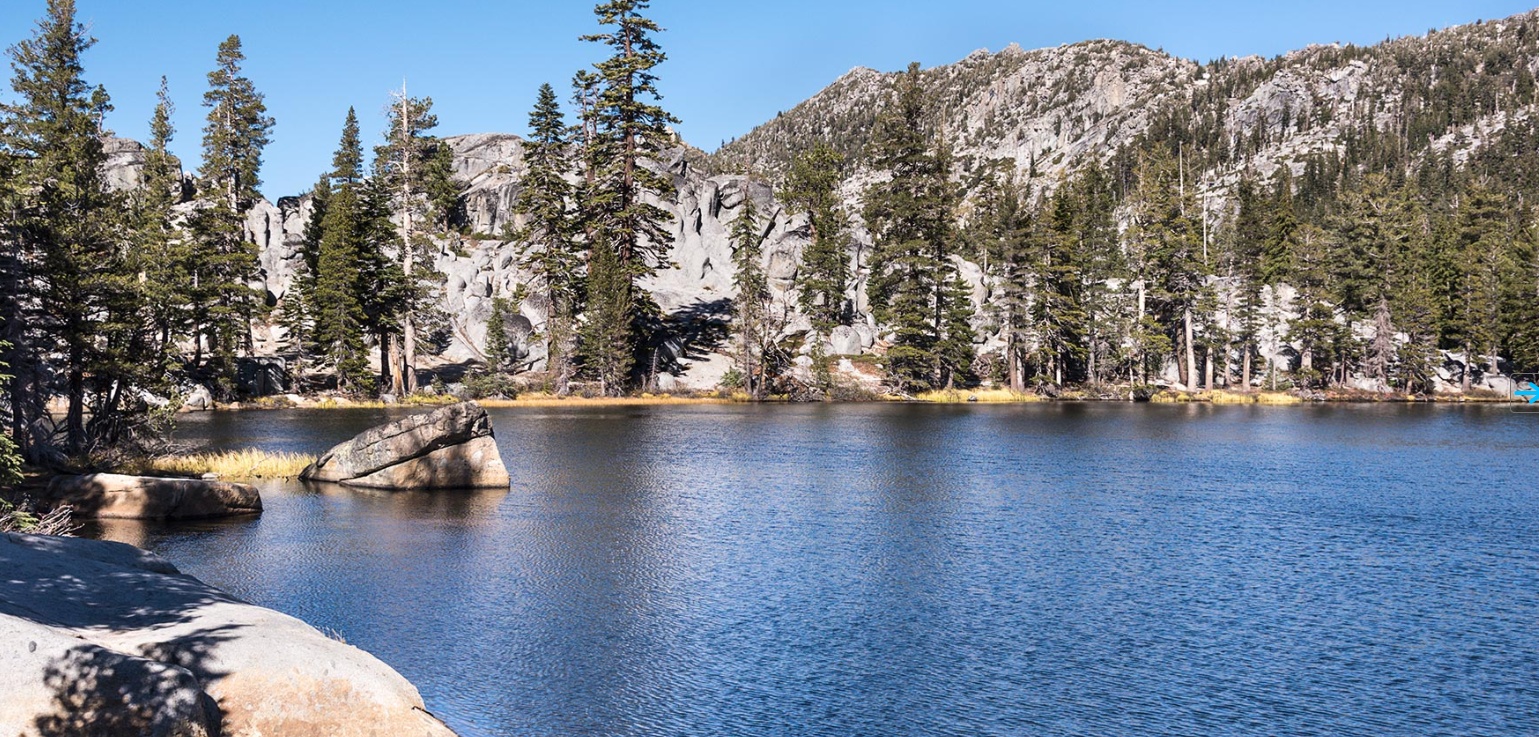 a lake surrounded by trees and rocks