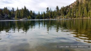a lake surrounded by trees and mountains