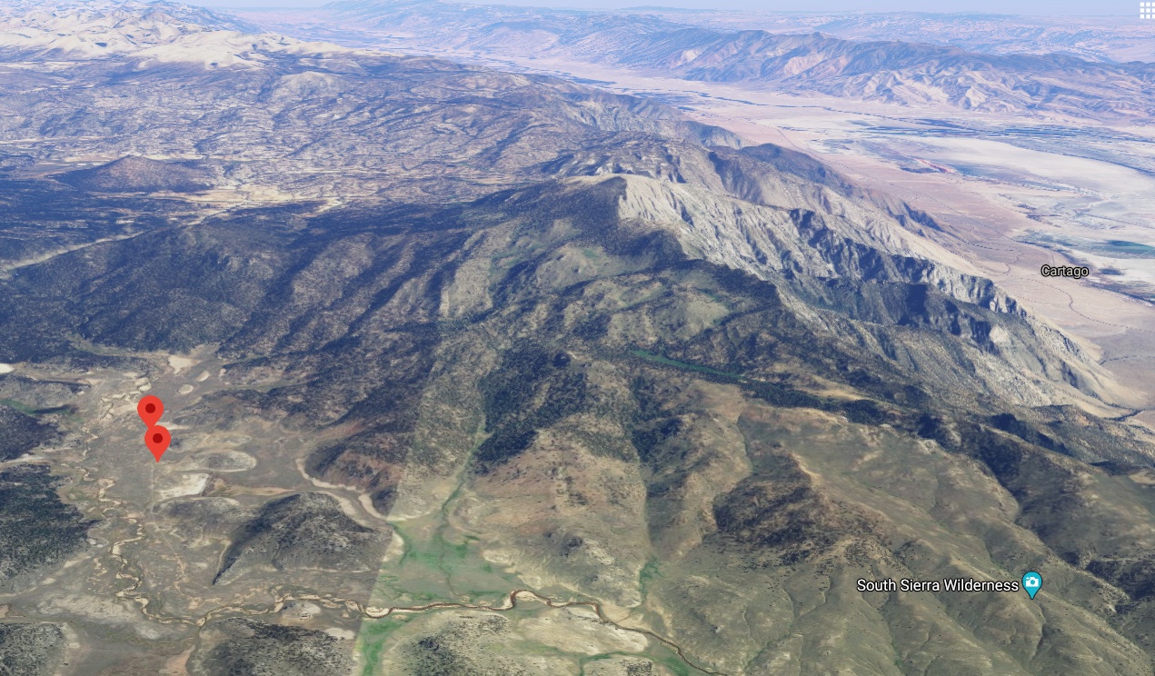 a google earth view of a mountain with a red arrow pointing to it