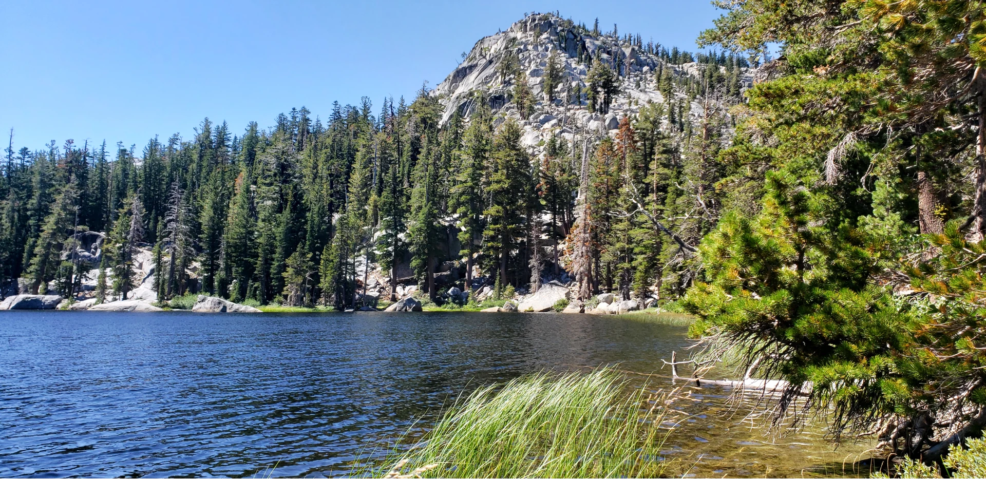 Rubicon lake with granite ride blue sky and grass