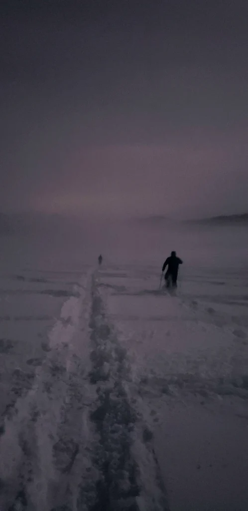 dark figure snowsoeing at night