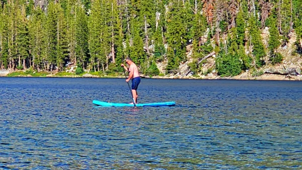 male paddleboarding on Tenaya Lake