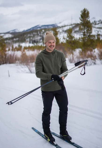 Guy crosscountry skiing in Rockcraft wool hoodie