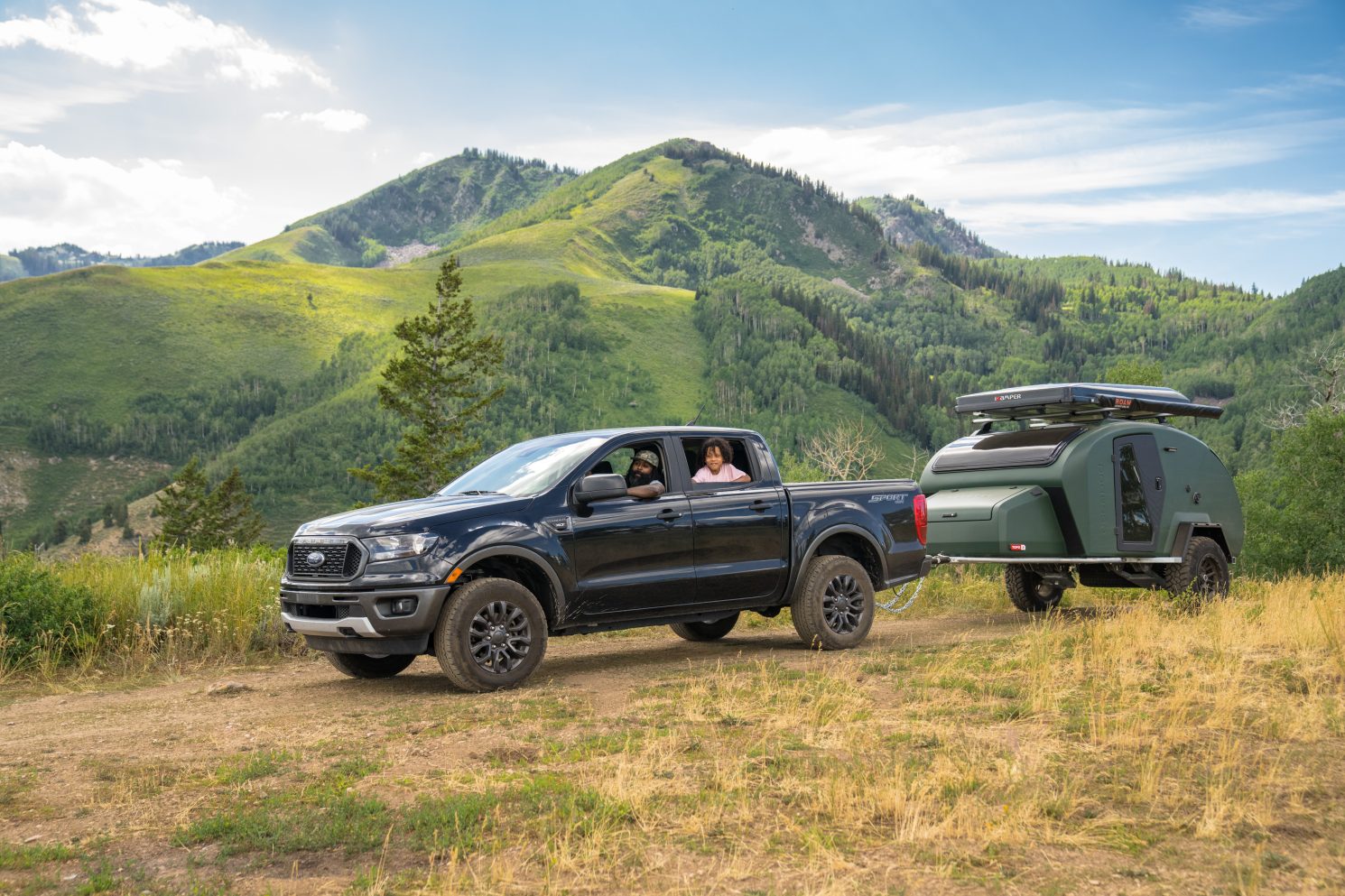 Guy and his son towing new Topo 3 MTB trailer in mountains