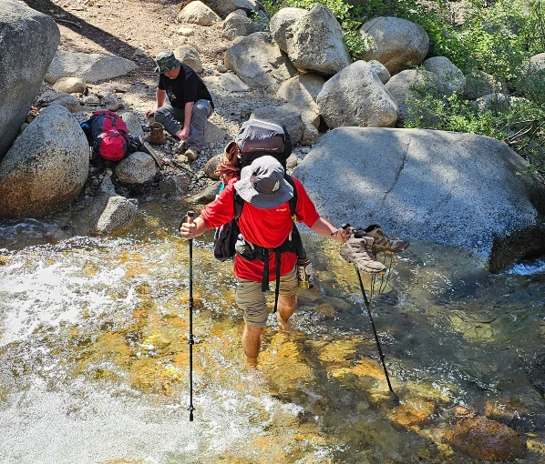 Two backpacker Water crossing Silliman Creek